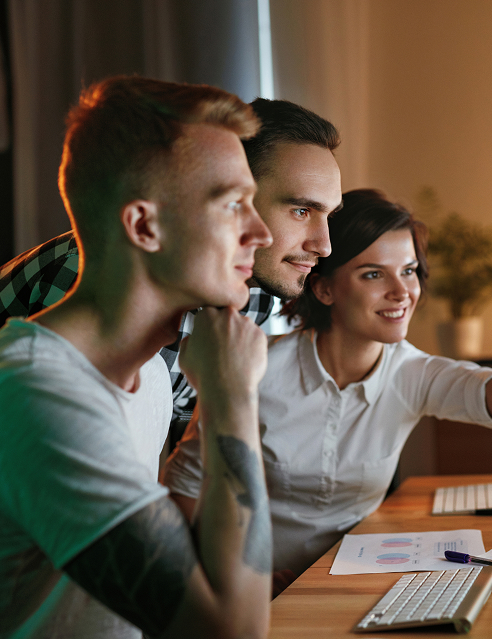 Un groupe de 3 personnes qui regardent un site internet